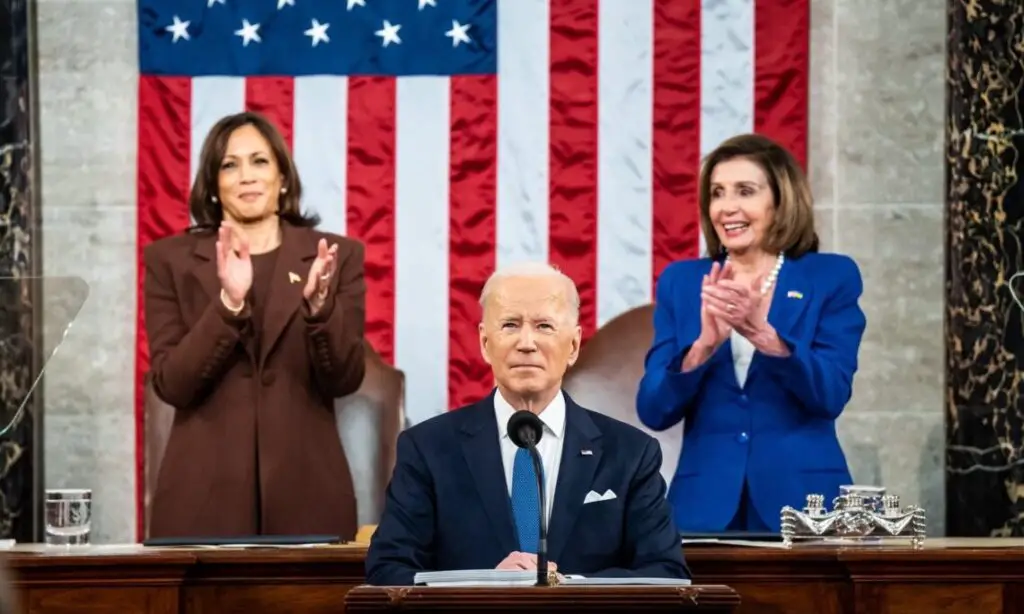 President Biden speaks during his first State of the Union speech. Vice President Kamala Harris (left), and Speaker of the House Nancy Pelosi (right) stand behind him.