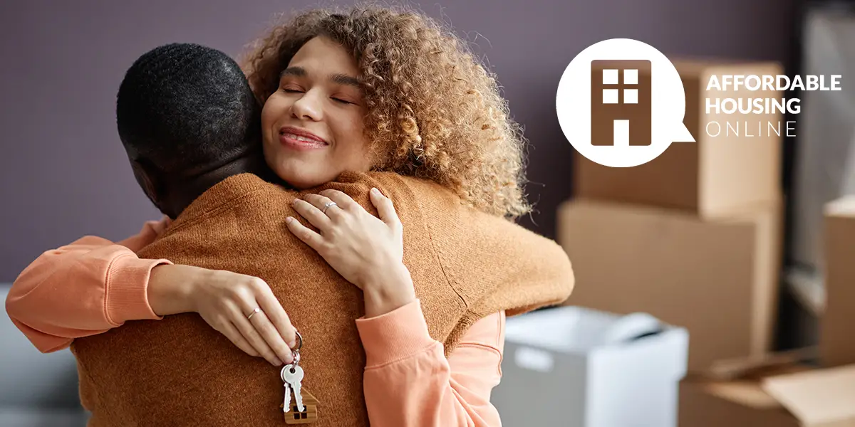 Section 8 Waiting List Announcements Banner image for the week of June 12, 2023 - Affordable Housing Online. Photo of a man and woman hugging each other as the woman faces the camera with the look of relief and a set of house keys in her hand, with the Affordable Housing Online logo.