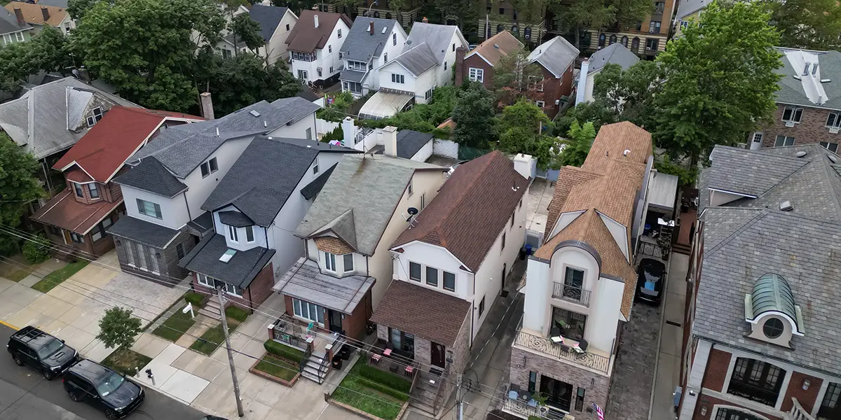 Overhead photo of two lines of single family homes in a city street.